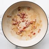 Frying bacon in a skillet.