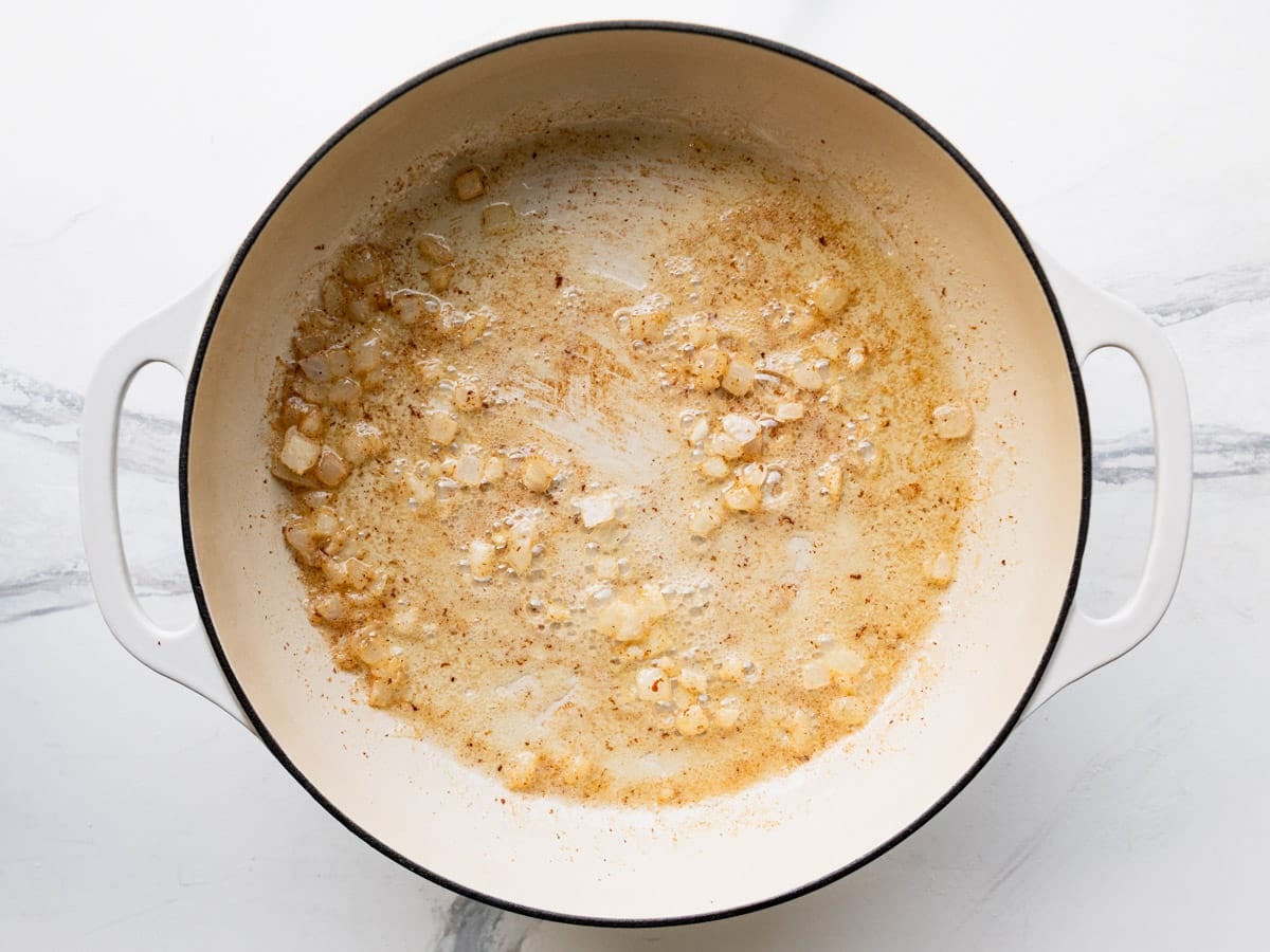 Sauteing onion in a skillet of bacon drippings.