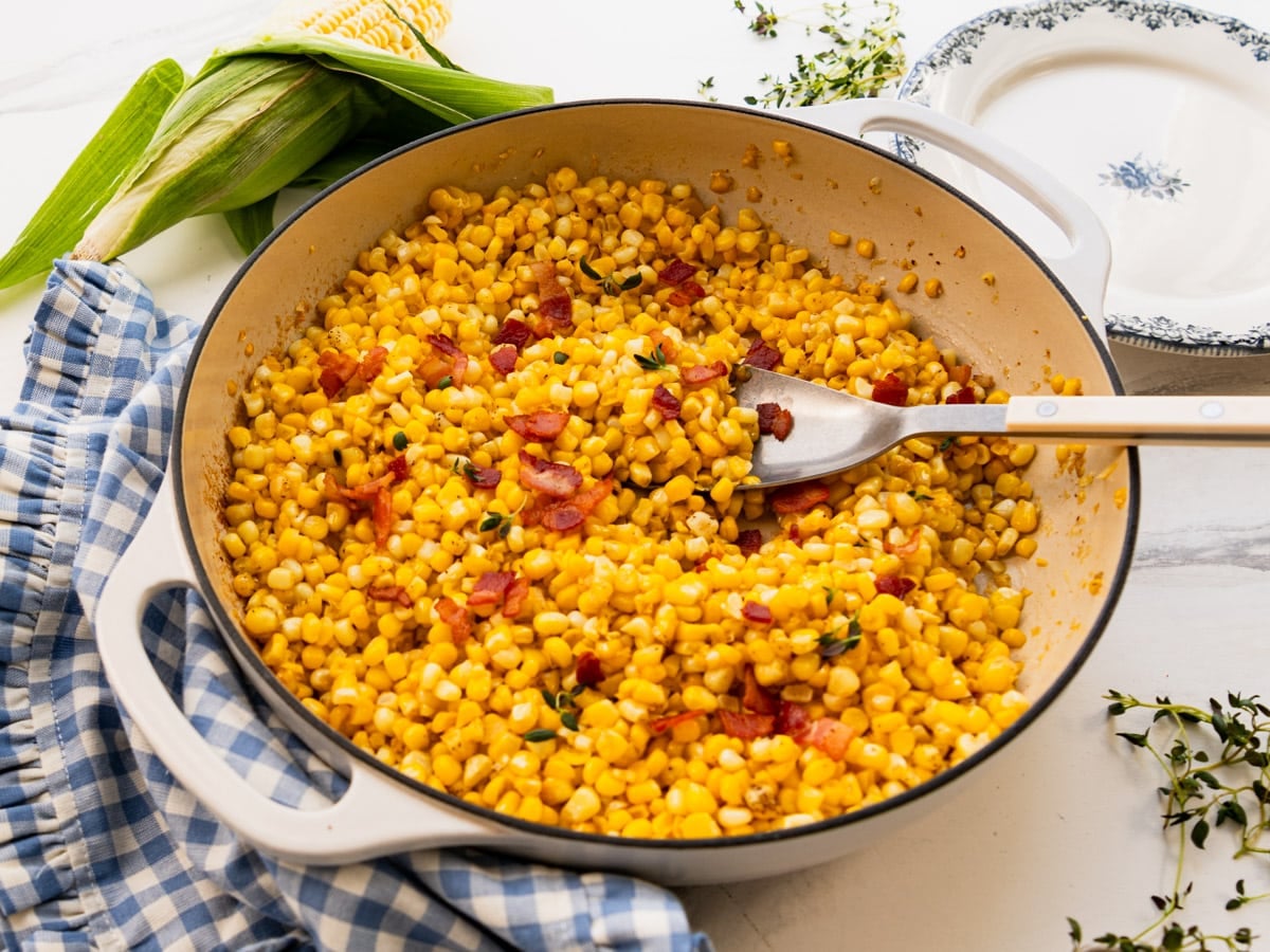Horizontal side shot of a skillet of Southern fried corn.