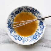 Whisking together the melted butter and sugar mixture.