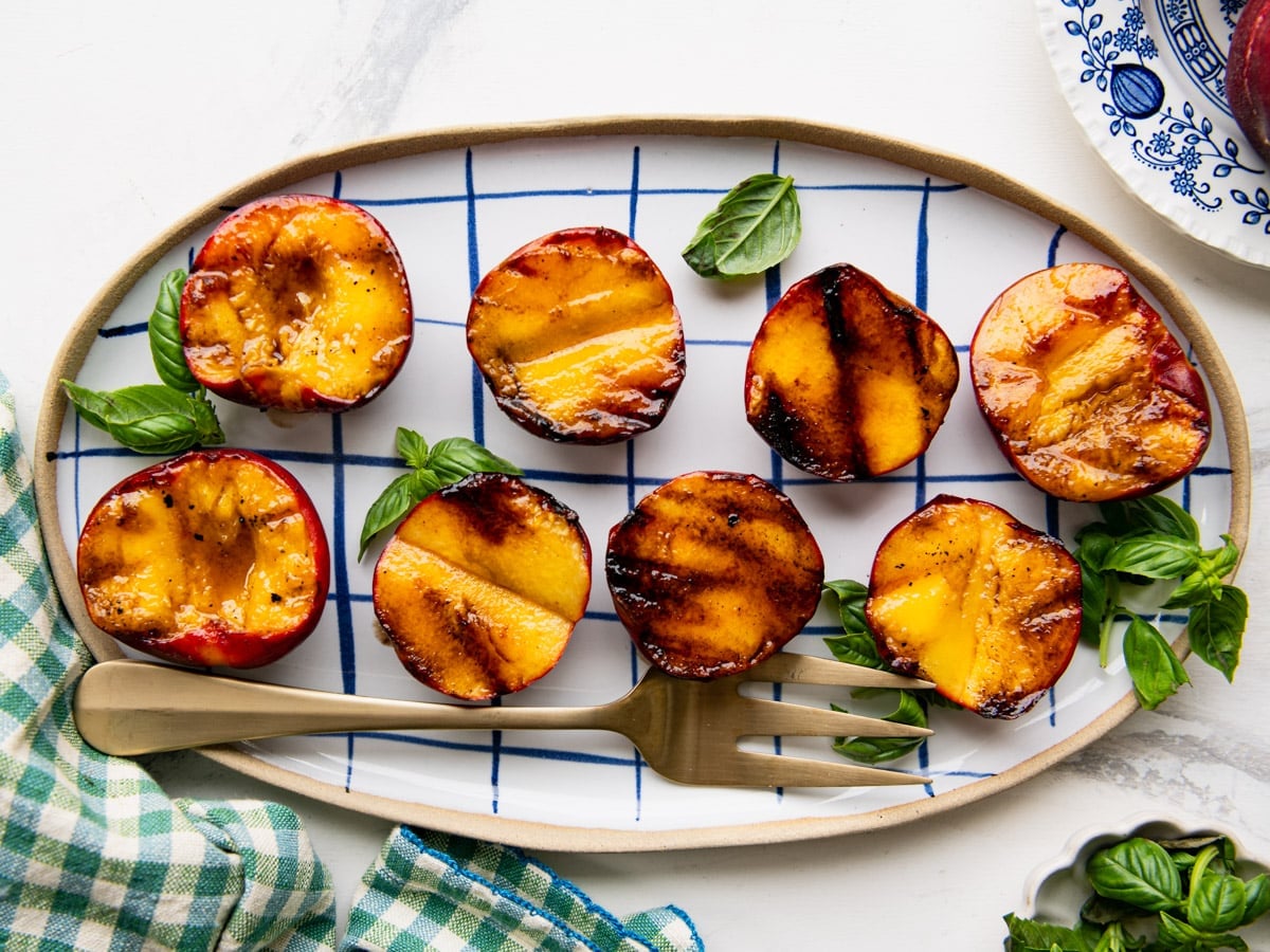 Horizontal overhead shot of a platter of grilled peaches.