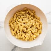 Cooked and drained pasta in a large mixing bowl.