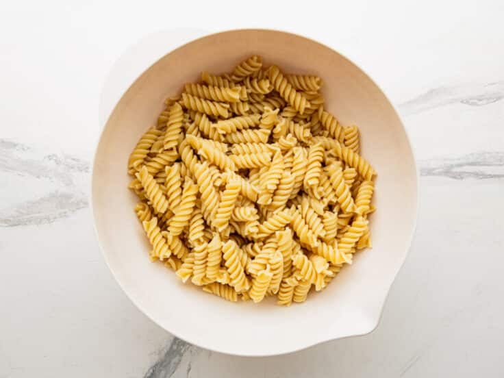 Cooked and drained pasta in a large mixing bowl.