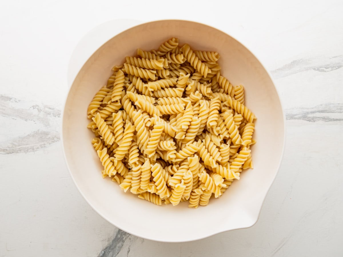 Cooked and drained pasta in a large mixing bowl.