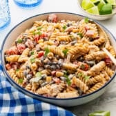 Close up horizontal side shot of a bowl of southwest pasta salad.