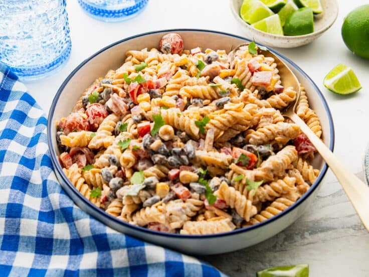 Close up horizontal side shot of a bowl of southwest pasta salad.