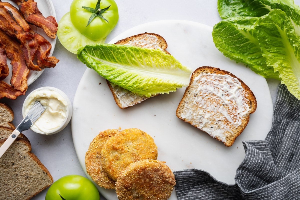 Lettuce on top of the bread spread with mayo.