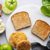 Toasted bread on a white plate.