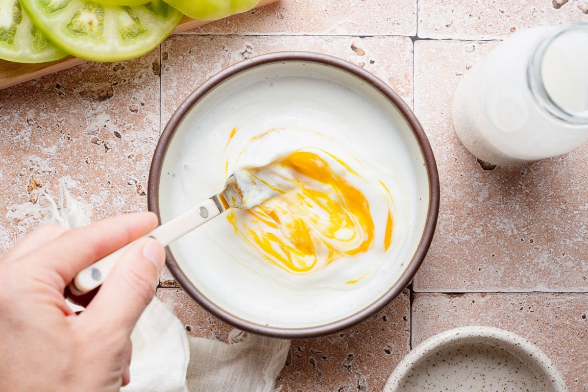 Mixing the egg and buttermilk mixture.