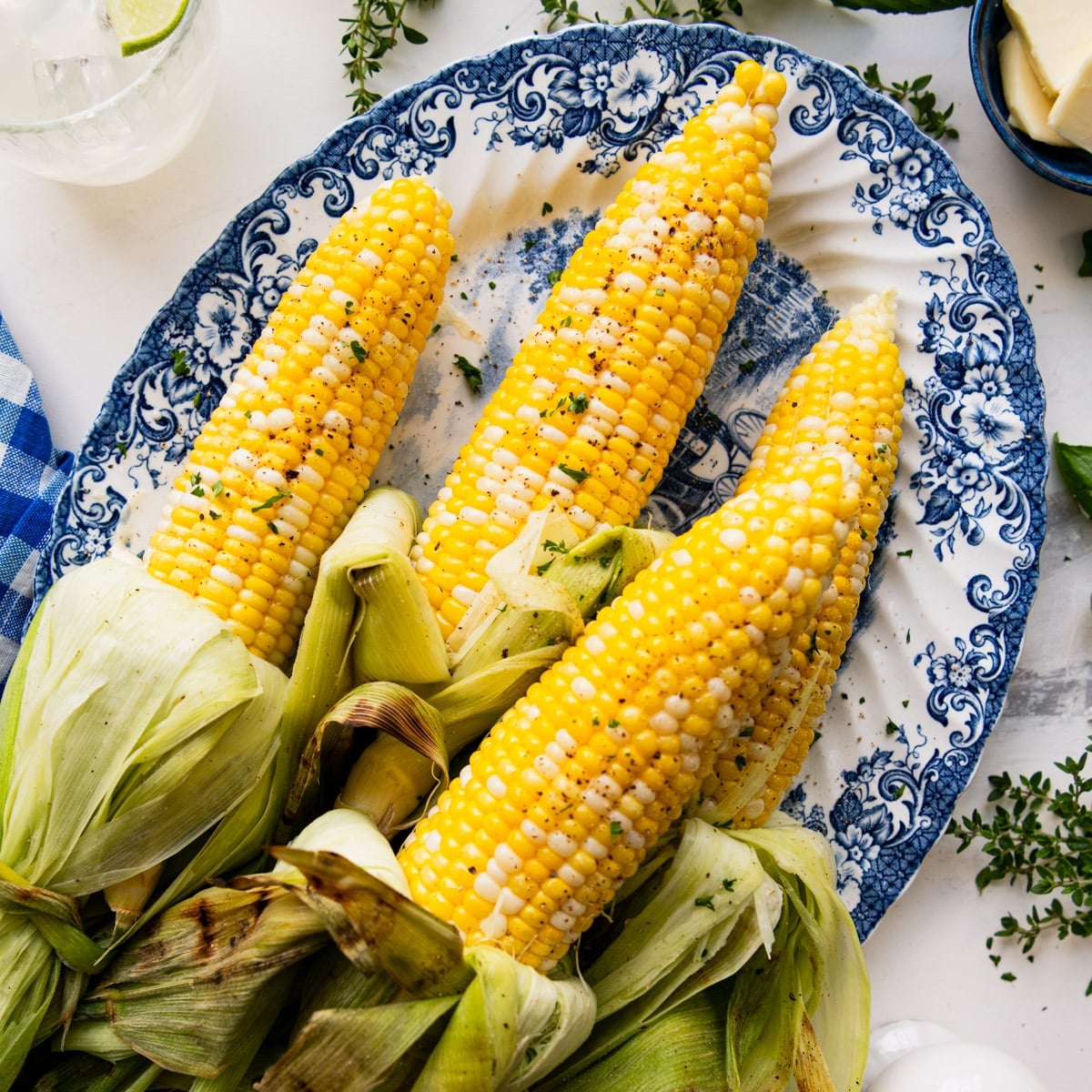 Square overhead shot of a platter of grilled corn on the cob.