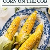 Grilled corn on the cob with a text title box at the top.
