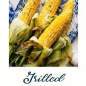 Grilled corn on the cob with a text title at the bottom.