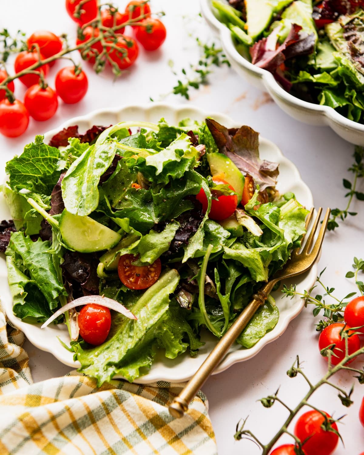 Side shot of a side salad on a white table.