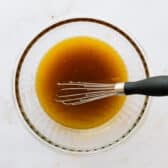 Whisking together the dressing.