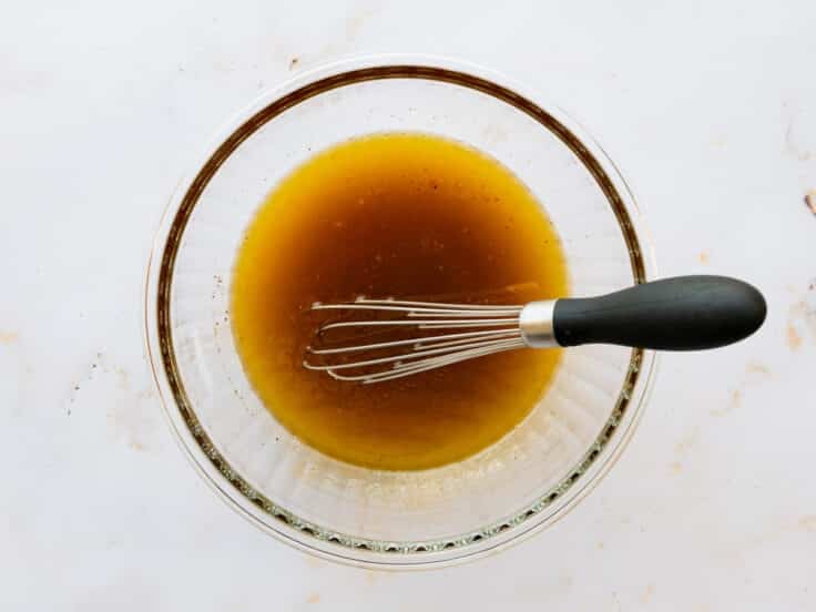 Whisking together the dressing.