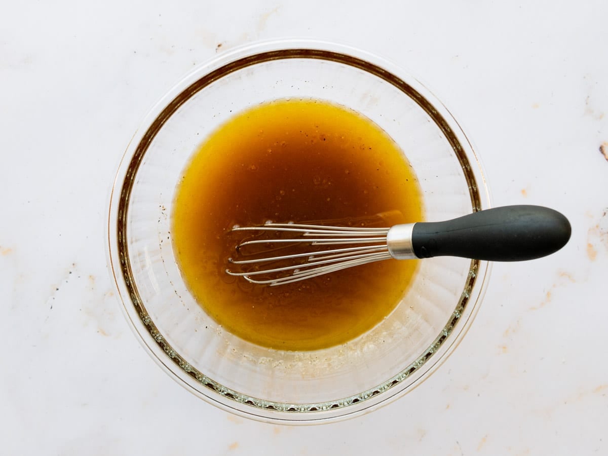 Whisking together the dressing.
