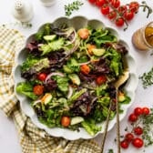 Horizontal overhead shot of a side salad in a white bowl.