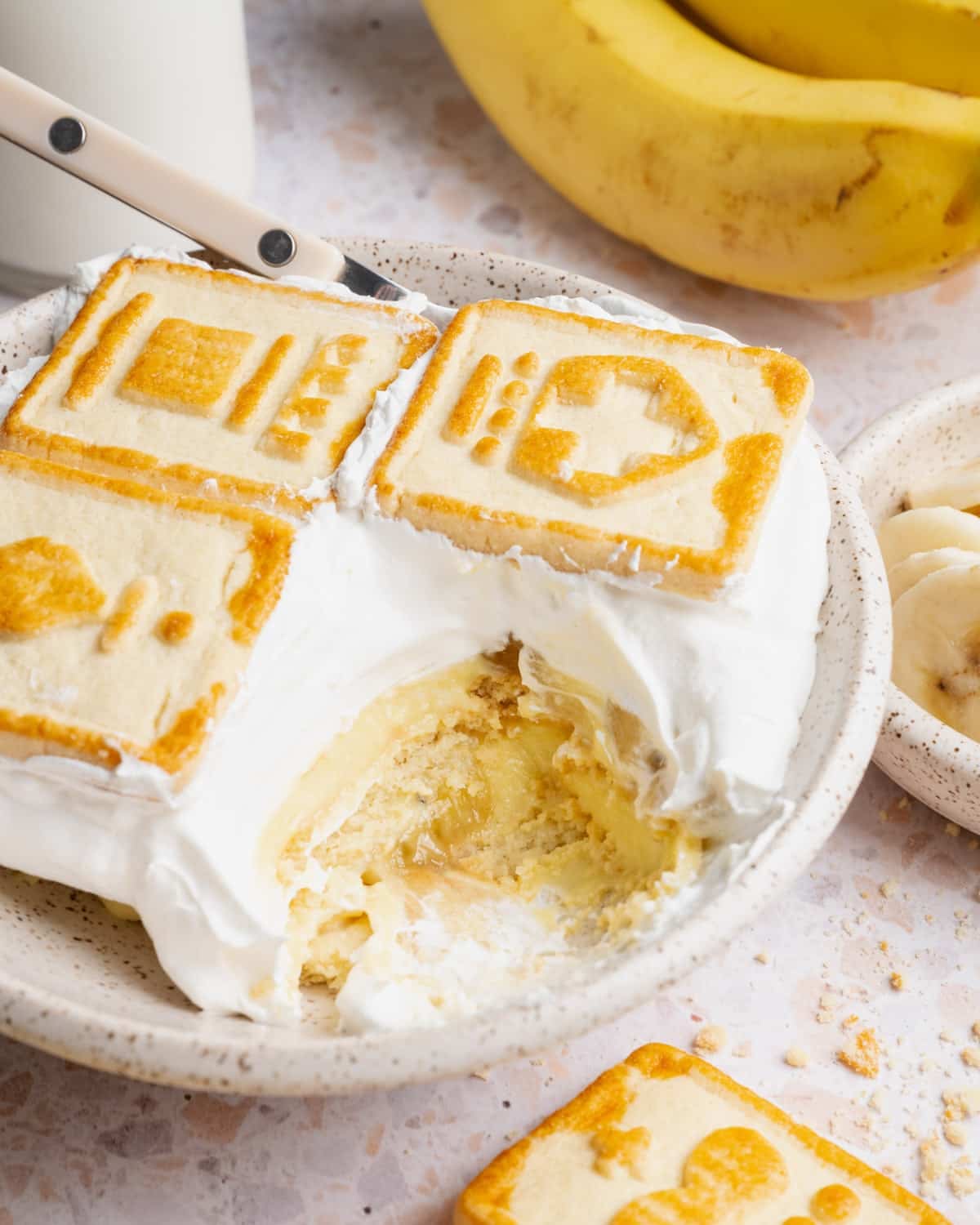 Side shot of chessman banana pudding served in a small white bowl.