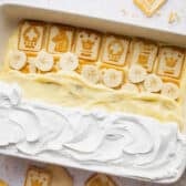 Horizontal overhead shot showing how to layer the ingredients for an easy no bake chessman banana pudding recipe.