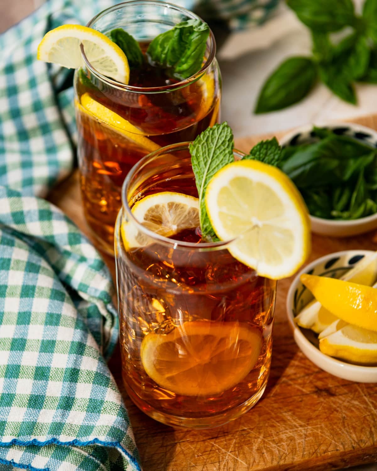 Overhead shot of glasses of sun tea with lemon wedges and fresh mint.