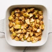 Apple filling tossed together in a white baking dish.