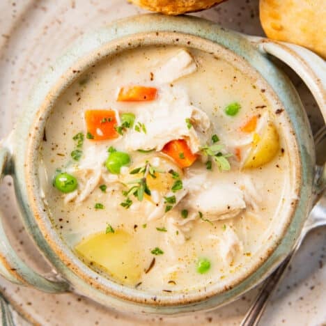 Square overhead chicken pot pie soup with biscuits on the side.