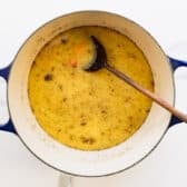 Adding the seasoning to the pot.