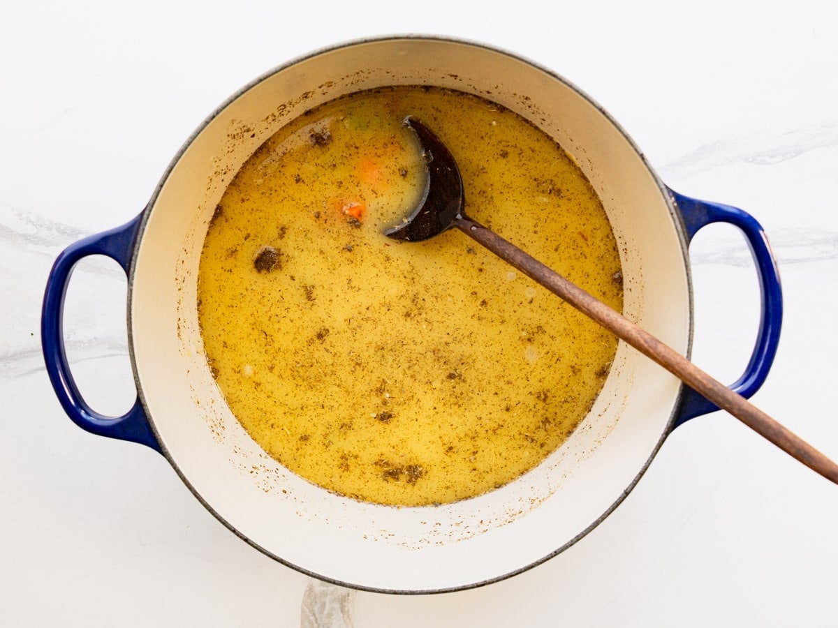 Adding the seasoning to the pot.