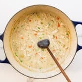 Stirring the cream into the pot of soup.