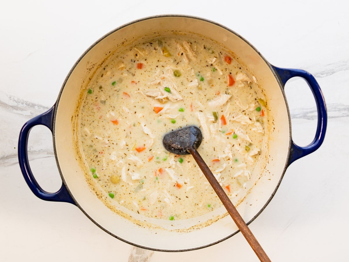 Stirring the cream into the pot of soup.