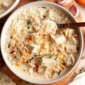 Square overhead shot of a bowl of creamy chicken and wild rice soup.