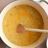 Adding the broth to the pot.