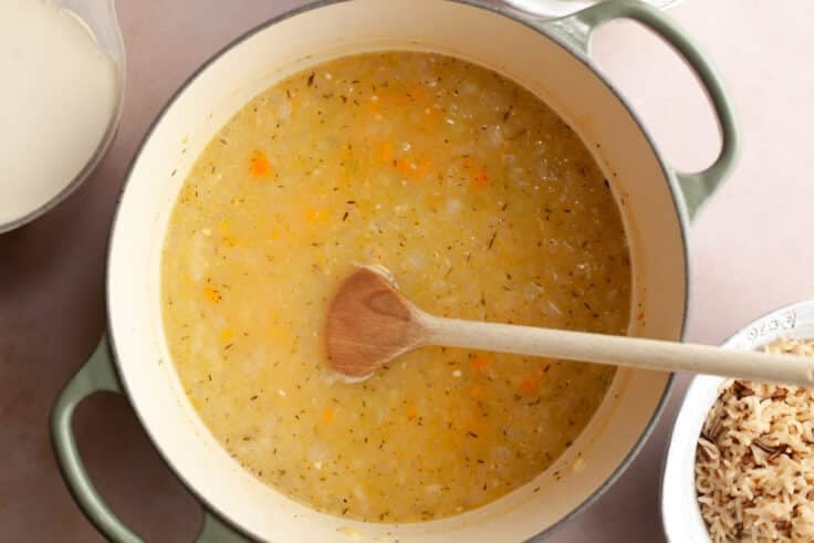 Adding the broth to the pot.