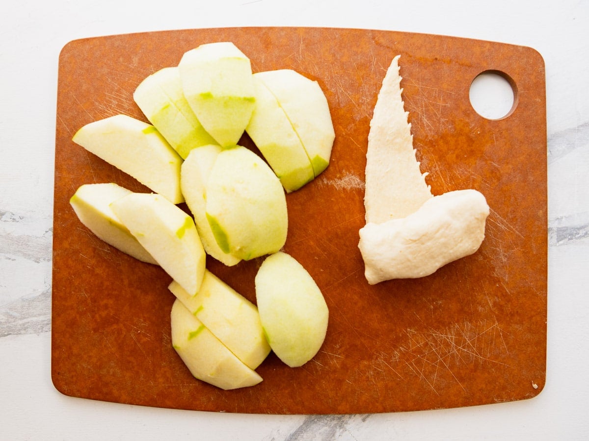 Wrapping apple wedges in the crescent roll triangles.