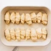 Arranging the apple dumplings in the baking dish.