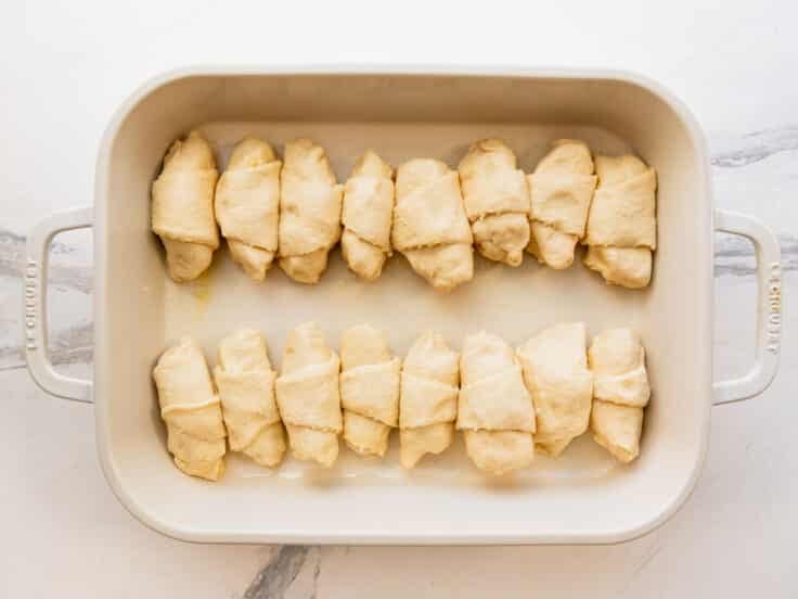 Arranging the apple dumplings in the baking dish.