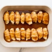 Pouring the brown sugar and butter mixture over the crescent rolls.