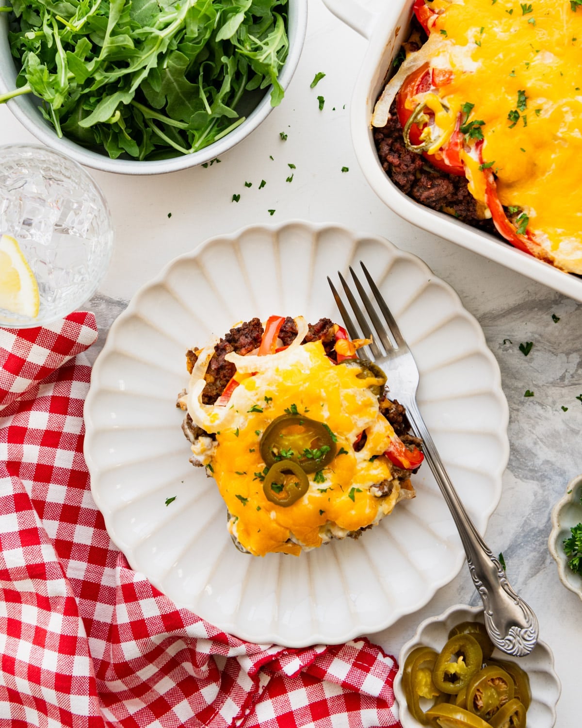 Overhead shot of a slice of John Wayne casserole on a white plate.