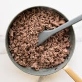 Browning ground beef in a skillet.