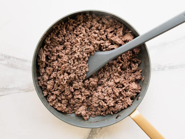 Browning ground beef in a skillet.