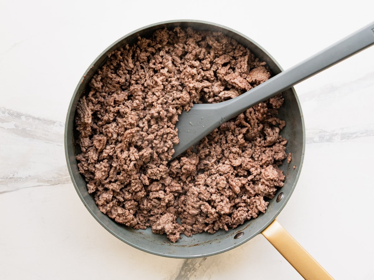 Browning ground beef in a skillet.