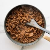 Cooked ground beef taco meat in a skillet.