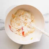 Stirring together the creamy mixture in a bowl.