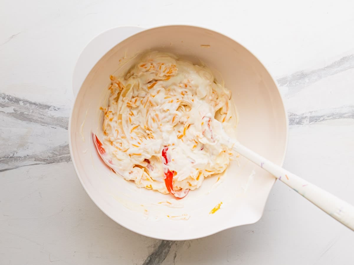 Stirring together the creamy mixture in a bowl.