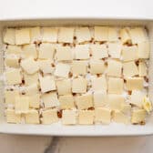 Pats of butter on top of the cake mix.