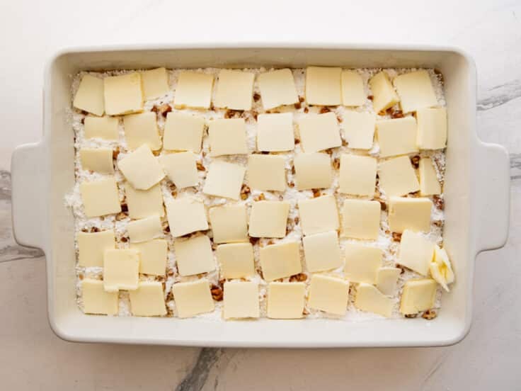 Pats of butter on top of the cake mix.