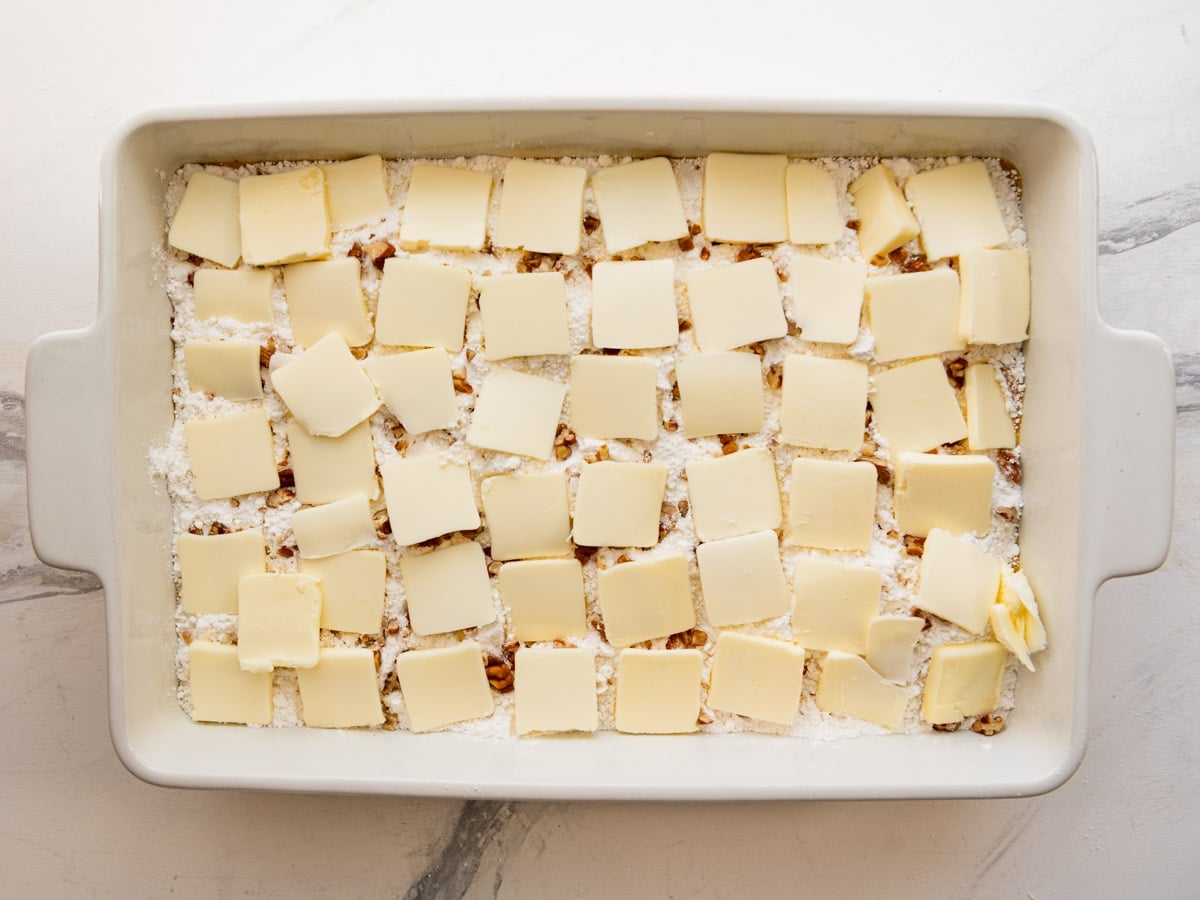 Pats of butter on top of the cake mix.