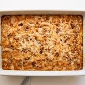 Horizontal overhead image of a white baking dish full of baked pumpkin dump cake.