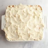 Spreading the mashed potatoes on top of a shepherd's pie.