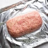 Meat mixture shaped into a loaf on the foil lined sheet pan.